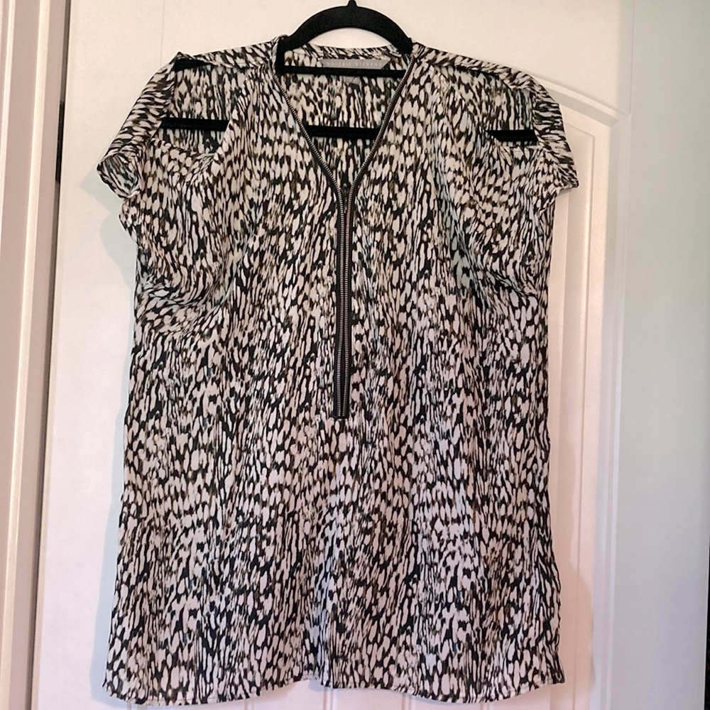 Peek- a-boo shoulder blouse with working zipper in front.